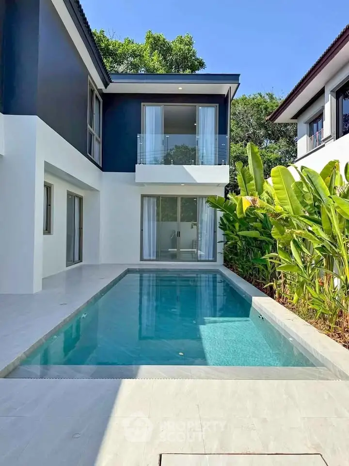 Luxurious modern villa with private pool and lush greenery, perfect for serene living.
