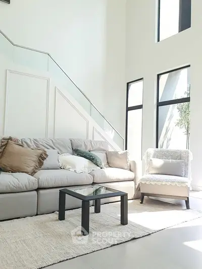 Spacious living room with modern decor and large windows for natural light.