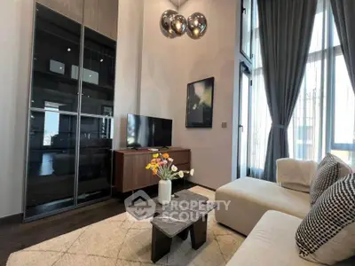 Luxurious modern living room with high ceilings, elegant decor, and large windows for natural light.