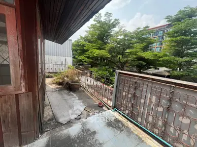 Charming balcony with lush greenery and city views, perfect for relaxation and outdoor enjoyment.