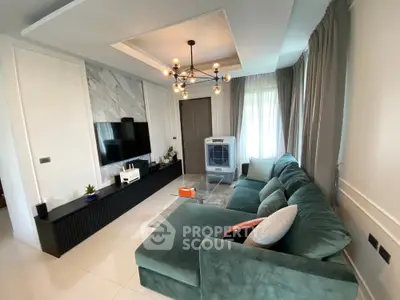Modern living room with stylish green sofa and elegant lighting
