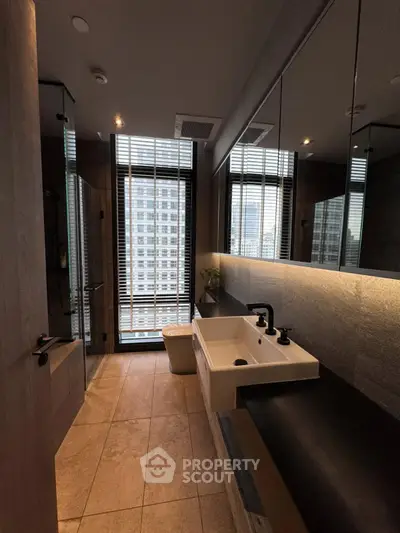 Luxurious modern bathroom with city view, featuring sleek fixtures and elegant design.