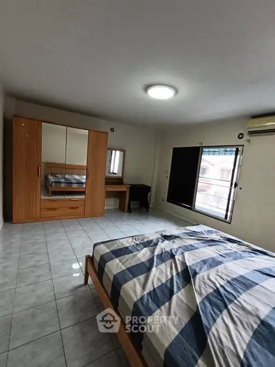 Spacious bedroom with large wardrobe and natural light