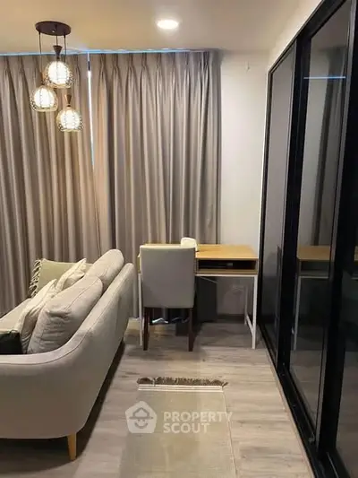 Modern living room with elegant sofa, study desk, and stylish lighting in a cozy apartment.