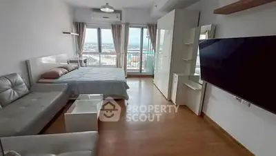 Spacious modern bedroom with large window and scenic view, featuring sleek furniture and contemporary design.