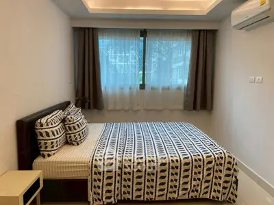 Cozy bedroom with stylish decor and large window for natural light