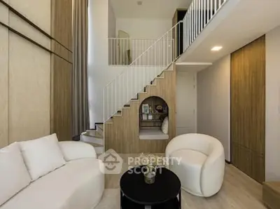 Modern living room with stylish furniture and mezzanine level, featuring neutral tones and elegant design.