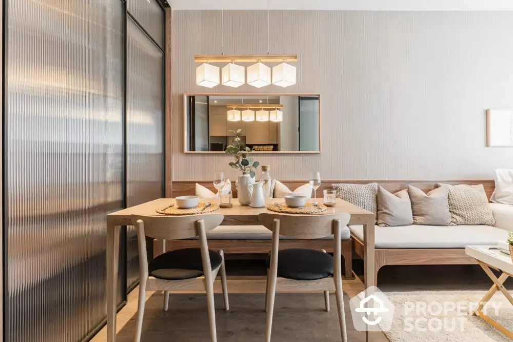 Modern dining area with elegant wooden furniture and stylish lighting in a cozy apartment.