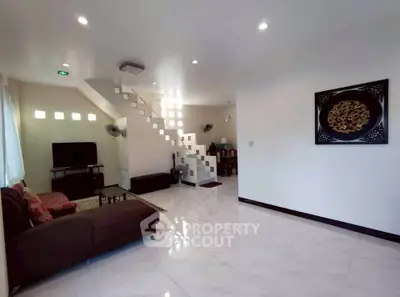 Spacious modern living room with elegant staircase and stylish decor