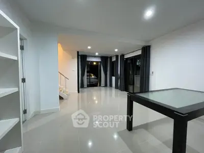 Spacious modern living room with sleek tile flooring and large windows