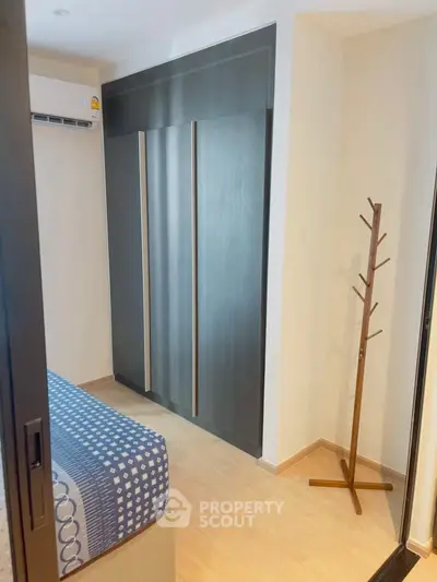 Modern bedroom with sleek wardrobe and stylish coat rack