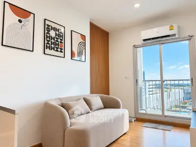 Modern living room with stylish decor and balcony view in a contemporary apartment.