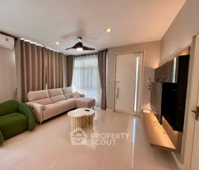 Modern living room with sleek furniture and natural light, perfect for relaxation and entertainment.