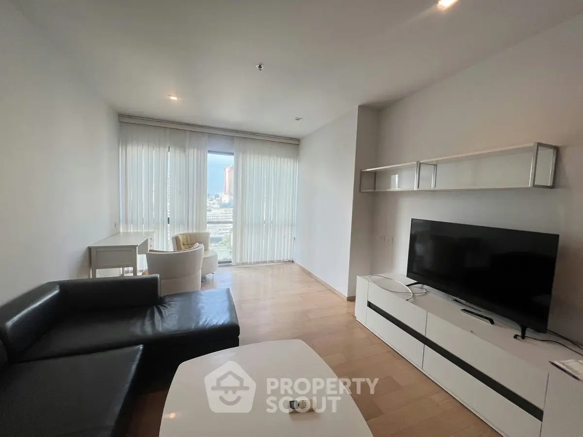 Modern living room with sleek furniture and city view, perfect for urban living.