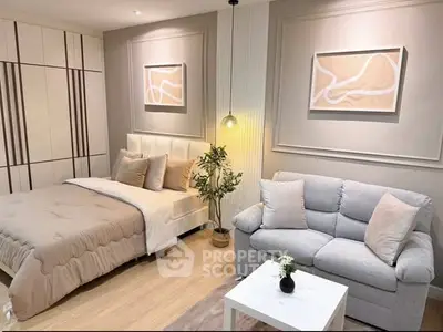 Stylish bedroom with cozy bed, modern sofa, and elegant decor in a chic apartment.
