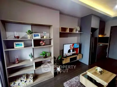 Modern living room with stylish shelving and cozy decor in a contemporary apartment.