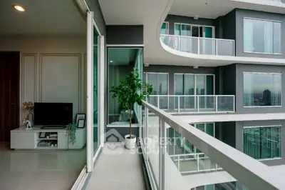 Modern apartment balcony with city view and sleek glass railing