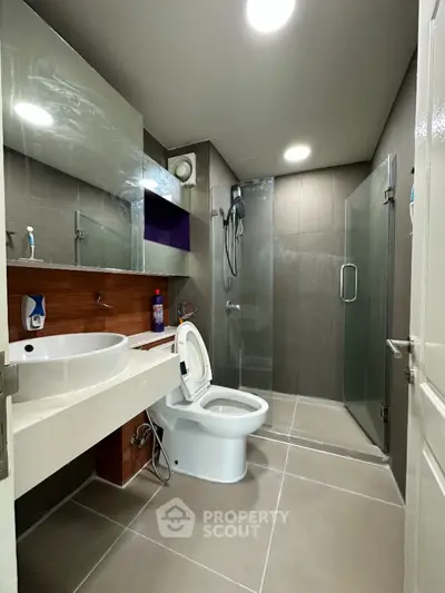Modern bathroom with glass shower and sleek fixtures