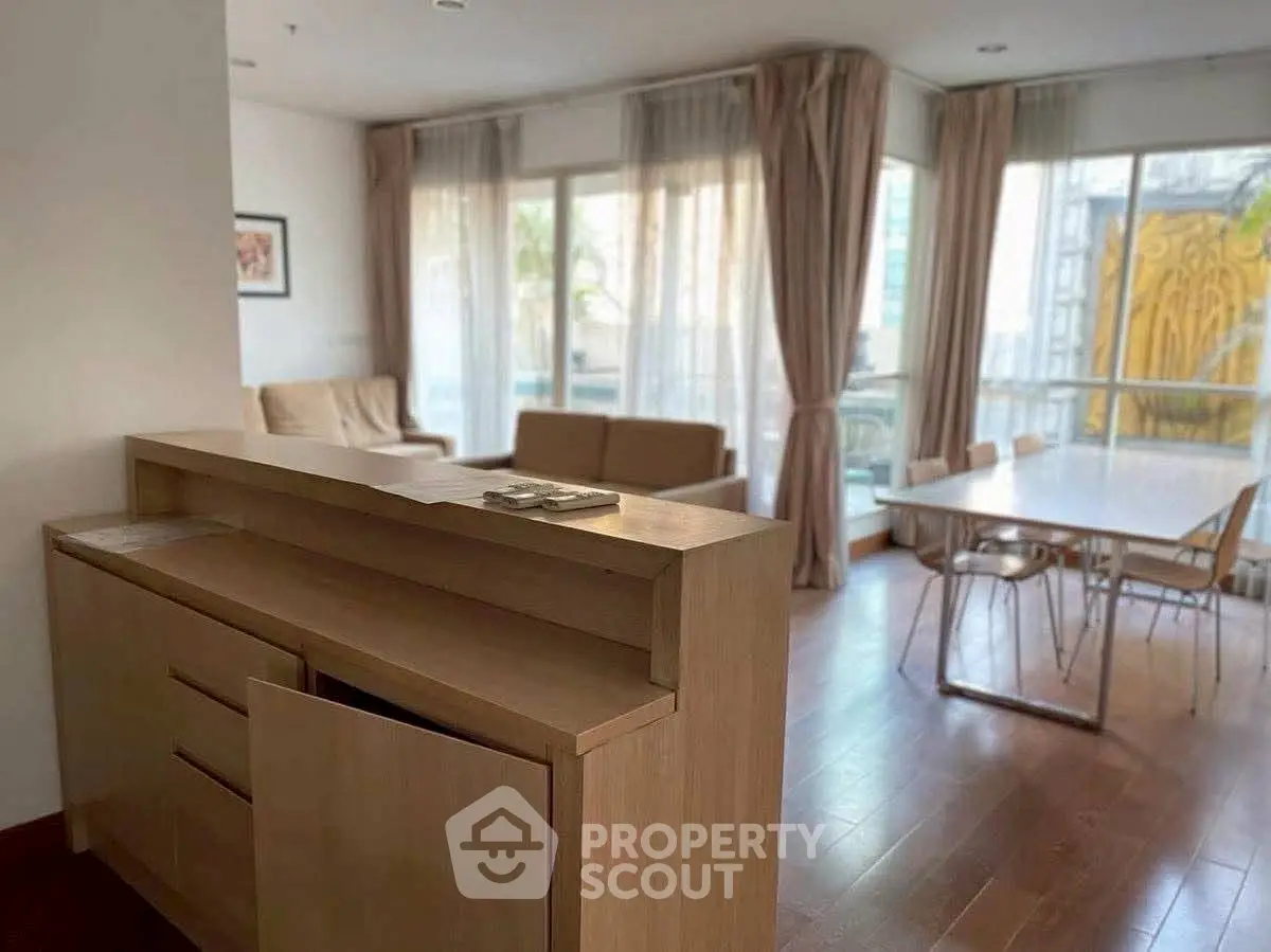 Spacious living room with modern furniture and large windows for natural light