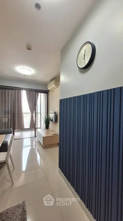 Modern living room with stylish decor and balcony view