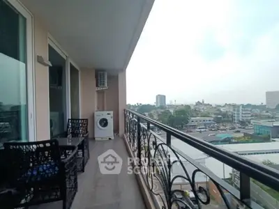 Spacious balcony with city view and outdoor seating, perfect for relaxation.