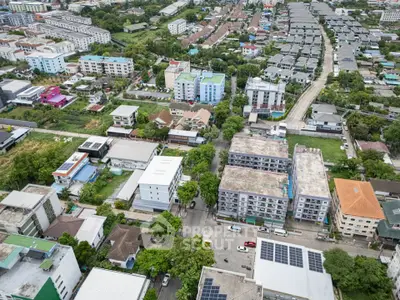 Aerial view of a vibrant residential neighborhood with diverse architecture and lush greenery.