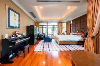Luxurious bedroom with elegant decor and large windows offering natural light.