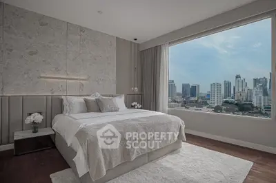 Luxurious bedroom with stunning city view, modern decor, and elegant furnishings in a high-rise apartment.