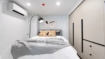 Modern bedroom with stylish decor and ample storage space
