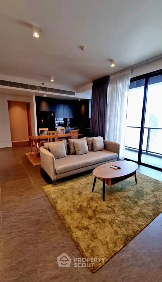 Spacious modern living room with open layout and balcony access