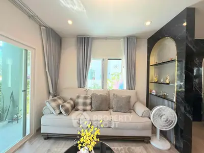 Stylish living room with elegant sofa, modern decor, and natural light.