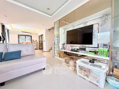 Spacious modern living room with sleek furniture and large TV unit