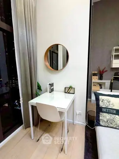 Modern study nook with sleek desk and chair, featuring a round mirror and city view, perfect for productivity.