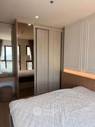 Modern bedroom with stylish decor and large windows offering city views.