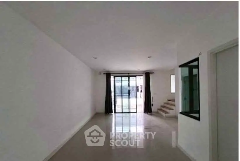 Spacious modern living room with large windows and sleek flooring