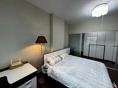 Spacious bedroom with modern decor and ample storage space