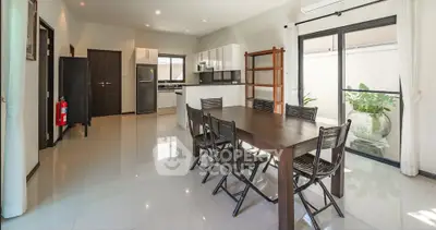 Spacious modern kitchen and dining area with sleek design and natural light.