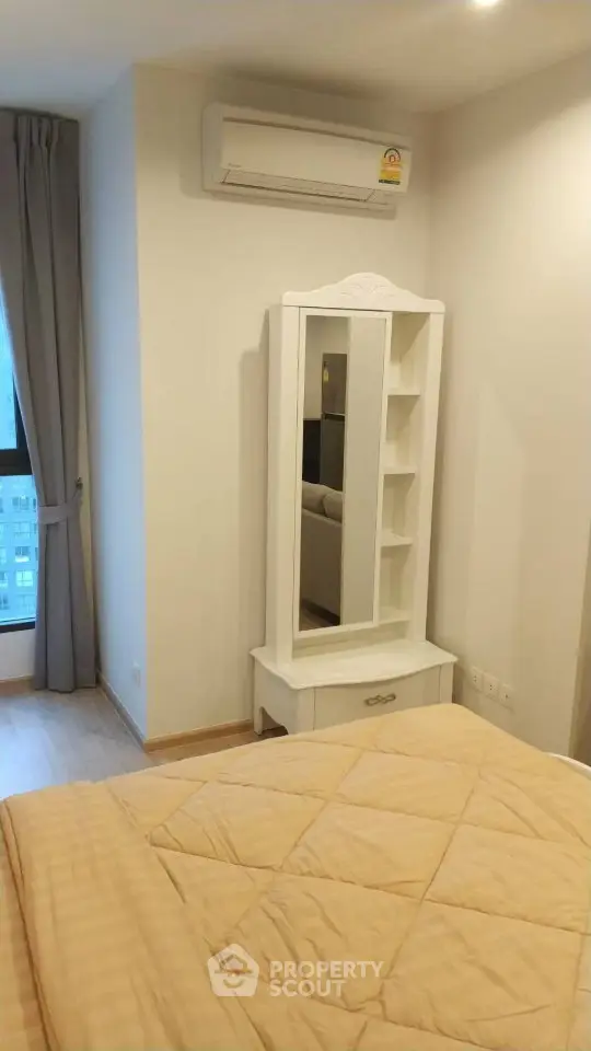 Cozy bedroom with air conditioning and elegant vanity in modern apartment