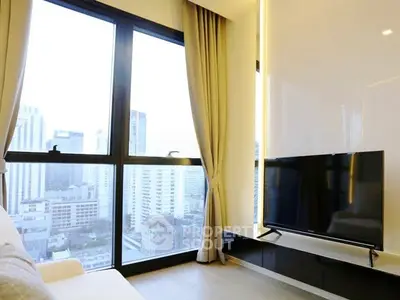 Modern living room with large window offering stunning city view and sleek TV setup.
