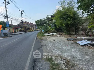 Vacant land plot on roadside with potential for development