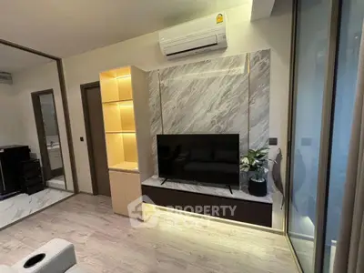 Modern living room with sleek TV setup and elegant marble accents