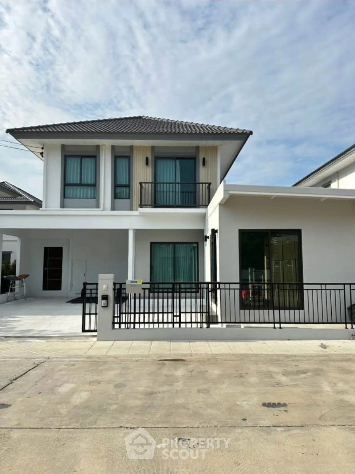 Modern two-story house with sleek design and spacious driveway