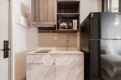 Modern compact kitchen with sleek cabinetry and appliances
