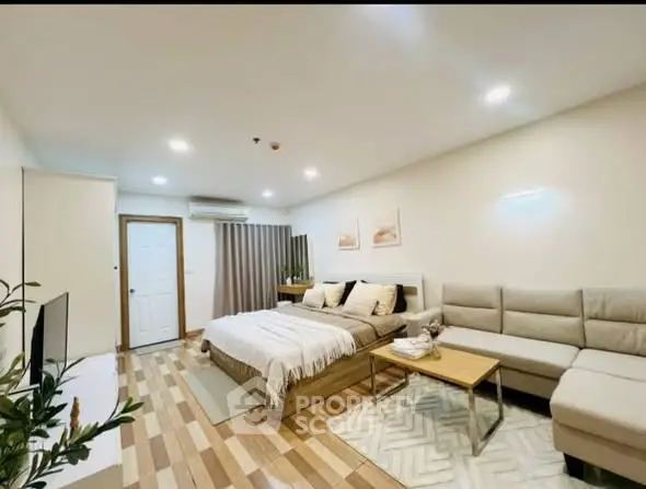 Modern and cozy bedroom with stylish decor and comfortable seating area.