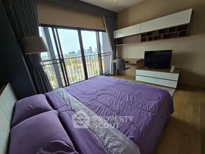 Spacious bedroom with city view, modern furniture, and natural light.