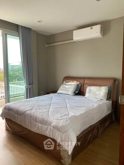 Spacious bedroom with modern decor and balcony access