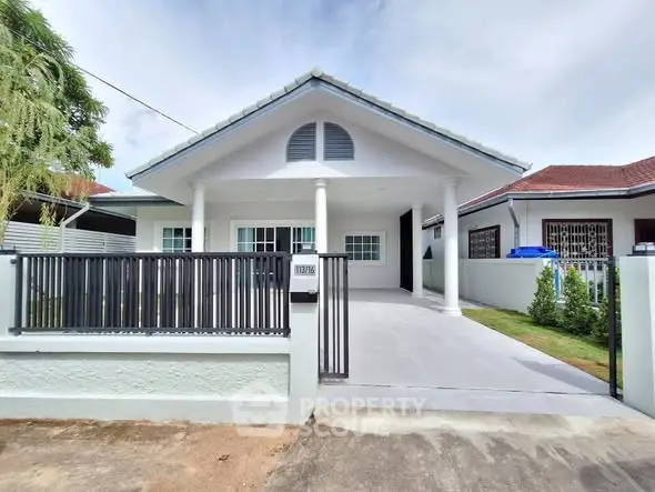 Charming single-story house with spacious driveway and modern exterior design.