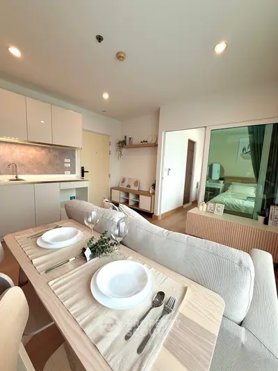 Modern open-plan living room with dining area and kitchen in stylish apartment