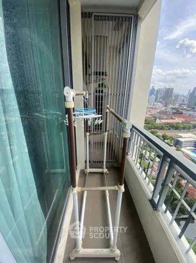 Compact balcony with city view, ideal for urban living and outdoor relaxation.