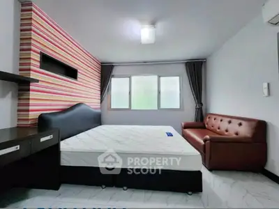 Spacious bedroom with modern decor and comfortable furnishings